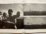 an open book with black and white photos of a man on a boat