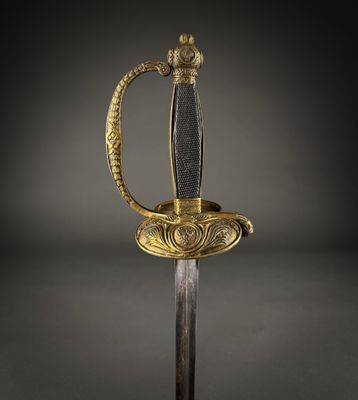 a gold and black sword with a handle on a black background