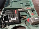 a green case with tools in it on a table