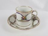 a cup and saucer on a saucer on a white table