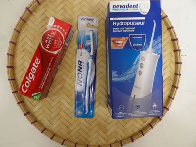 two toothbrushes and a tube of toothpaste on a tray