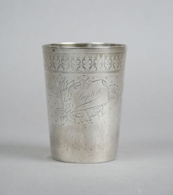 a silver cup that is sitting on a table