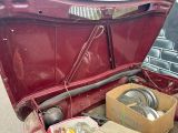 a trunk of a car with a bunch of items inside of it