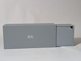 a gray box with a lid that is open on a white surface