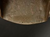 a close up of a metal object on a black surface