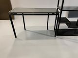 black glass desk with shelves and a mirror on the top