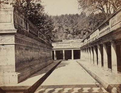a black and white photo of a courtyard in the middle of the day