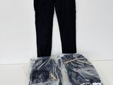 a pile of jeans and a pair of pants sitting on a table