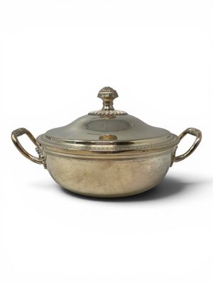 an antique silver plated casserole with a lid and handles