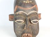 an image of a close up of a wooden mask on a white background