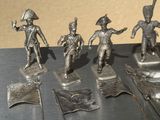 five figurines of soldiers on display on a table