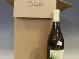 a bottle of wine sitting next to a cardboard box