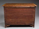 an old wooden chest sitting on top of a white floor