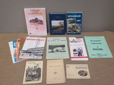 several books are sitting on a table in front of a wall
