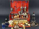 a red suitcase with various items in it on a table