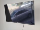 a flat screen tv mounted on the wall in a living room