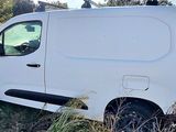 a white van that is parked in the grass