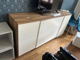 a television sitting on top of a cabinet in a living room