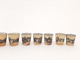 six shot glasses with a picture of a village on them