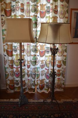 two lamps that are sitting on a rug in front of a window