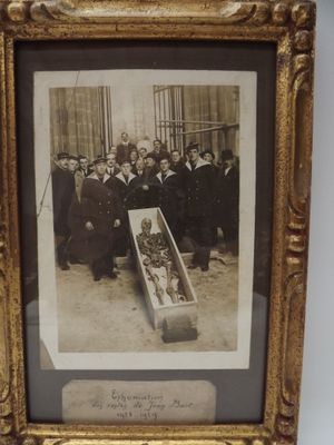 an old photo of a group of people standing around a coffin