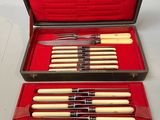 an image of a case with six knives and a set of chopsticks