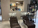 a picture of a salon with two chairs and a counter