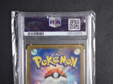 the pokemon card is in a plastic case on a black surface
