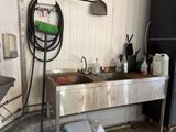 a kitchen with a sink and a refrigerator in it