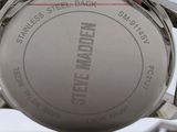 a close up of a watch on a white surface