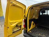a yellow van with the door open in a parking lot