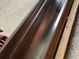 the man is working on the metal window sill in the garage
