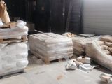 a pile of mattresses and other items in a room