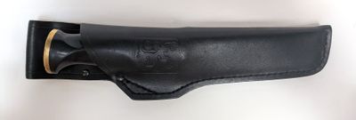 a close up of a black leather holster on a white wall