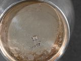 a close up of a silver vase on a table