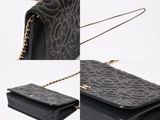 a close up of a black purse on a white background