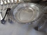 a silver plate on a table with silver utensils