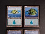 four cards with a picture of a small island in the middle of them