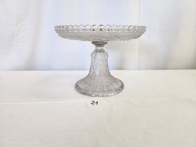 a glass cake plate on a table with a white background
