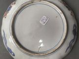 a white plate with blue and red designs on it