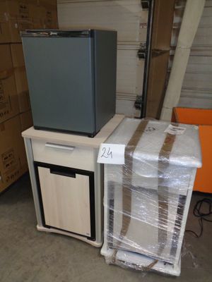 a television sitting on top of a cart in a warehouse