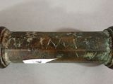 a close up of a metal pipe with a tag on it