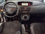the interior of a small car with a steering wheel and dashboard
