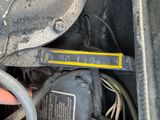 a close up of a car ' s engine with a yellow tag on it