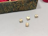 four dice sitting on top of a table next to a box of yarn