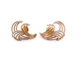 a pair of gold earrings on a white background