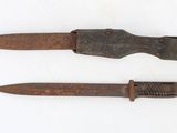 two old rusty knives on a white surface