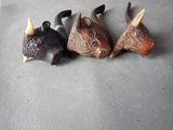 three small figurines of animals that are on a table