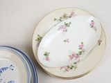 two plates with flowers on them sitting on a table