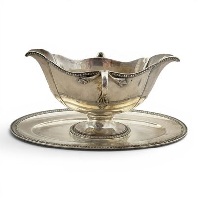 an antique silver plate with a saucer on it on a white background